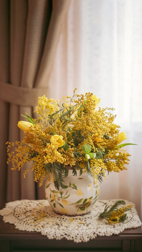 Photo of a bouquet of yellow mimosa and tulips by the window preview