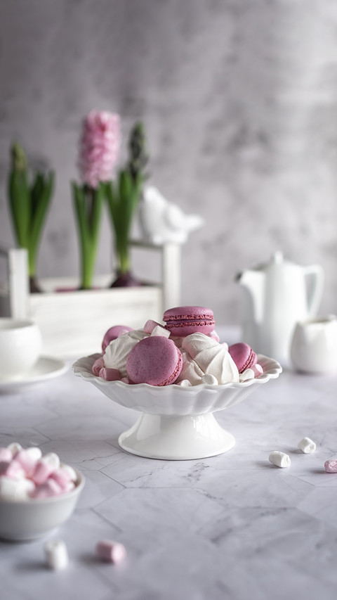 Marshmallows and macaroons in a white porcelain vase preview