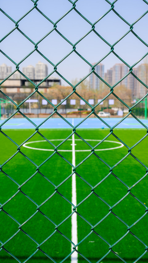 A bright and sunny urban community football field preview