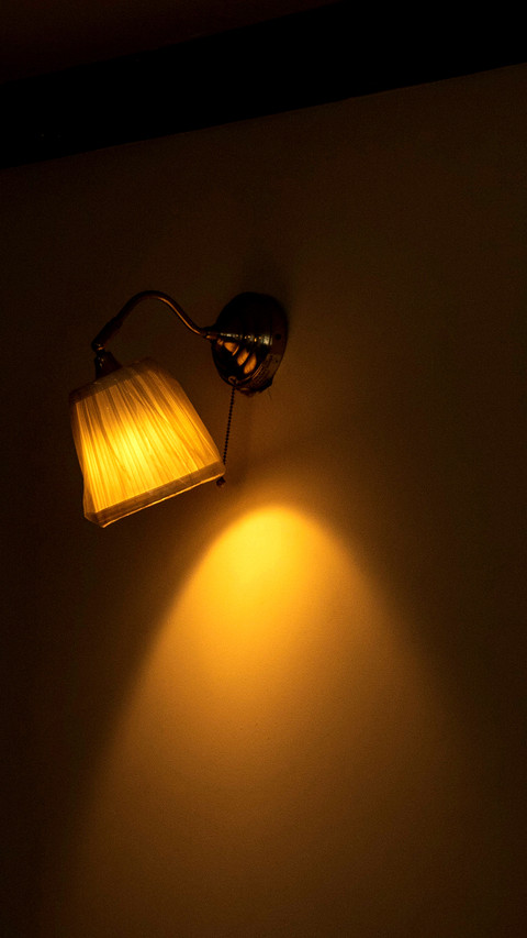 Lamp lit in living room illuminating wall preview