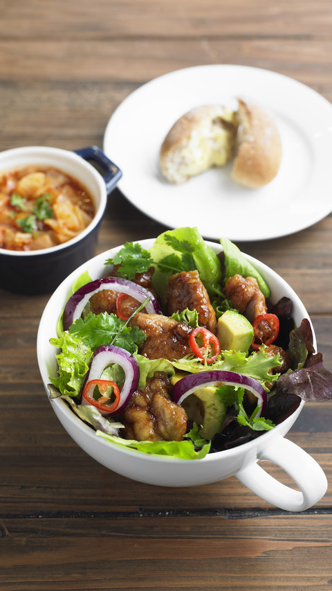 Chicken pieces in salad with red onion and avocado preview
