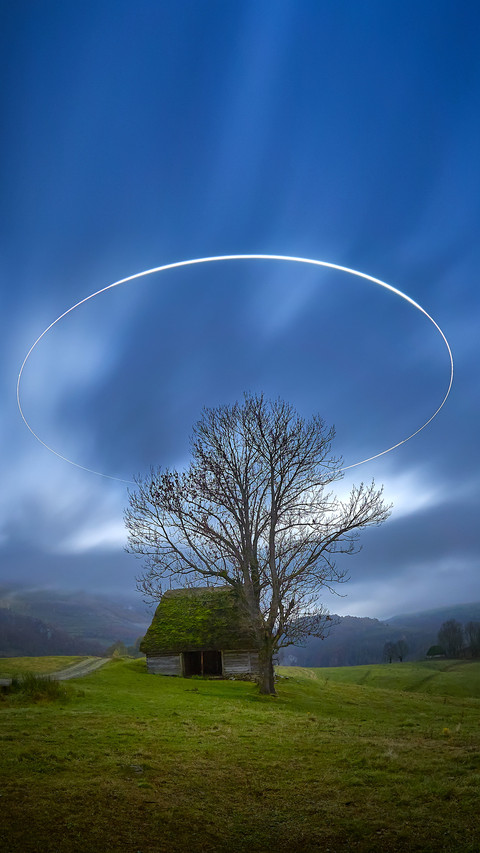 Landscape by night with circle of light over the hills preview