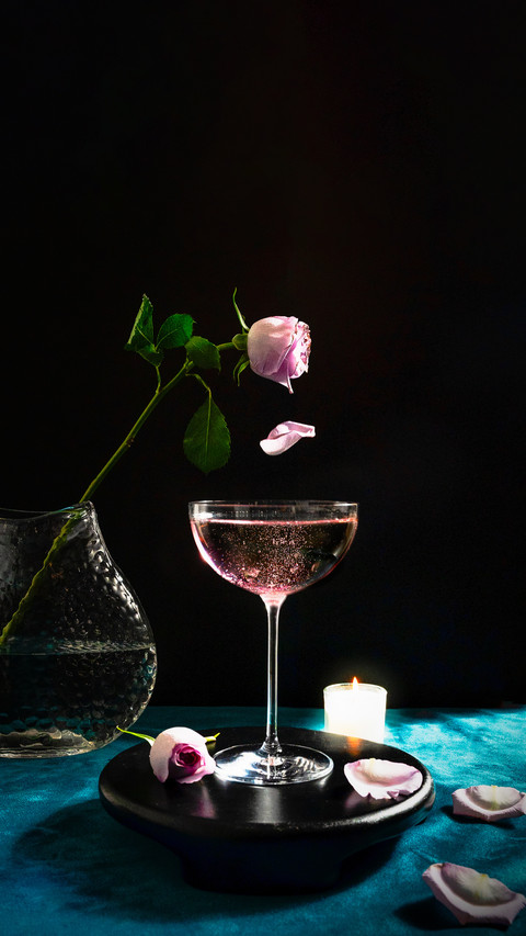 Champagne Cocktails with Pink Rose and a Candle preview