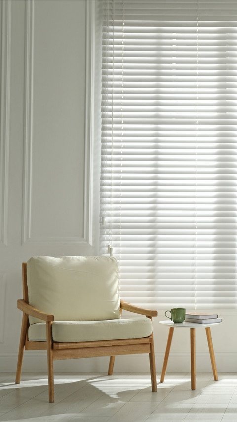 Cosy armchair and houseplant near large window preview