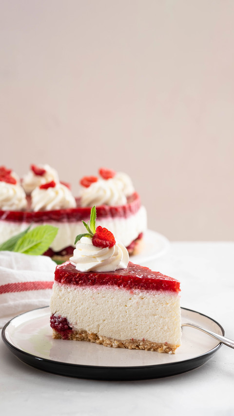 Cheesecake slice with fresh raspberries and mint leaves preview