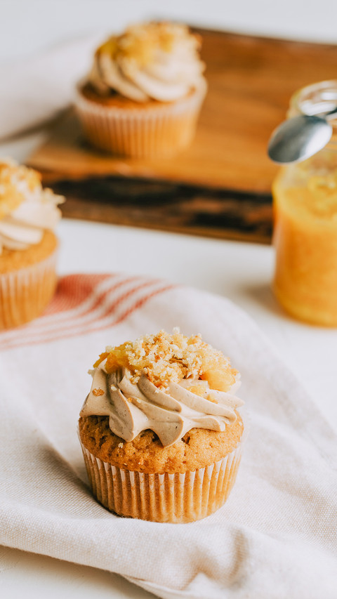 Yellow marmalade cupcakes on the rustic wooden table preview