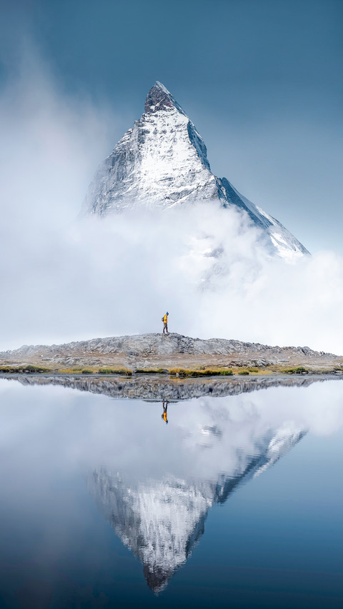 Hiker Man Walks Alone Through the Incredible Swiss Alps preview