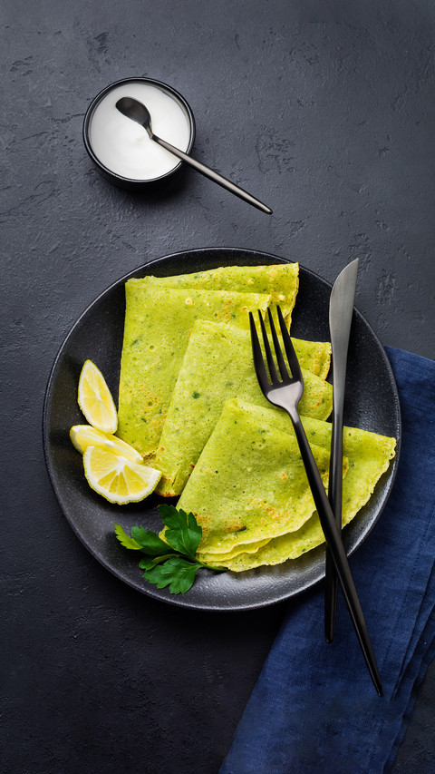 Crepes of Spinach with Yoghurt Sauce on Black Concrete preview