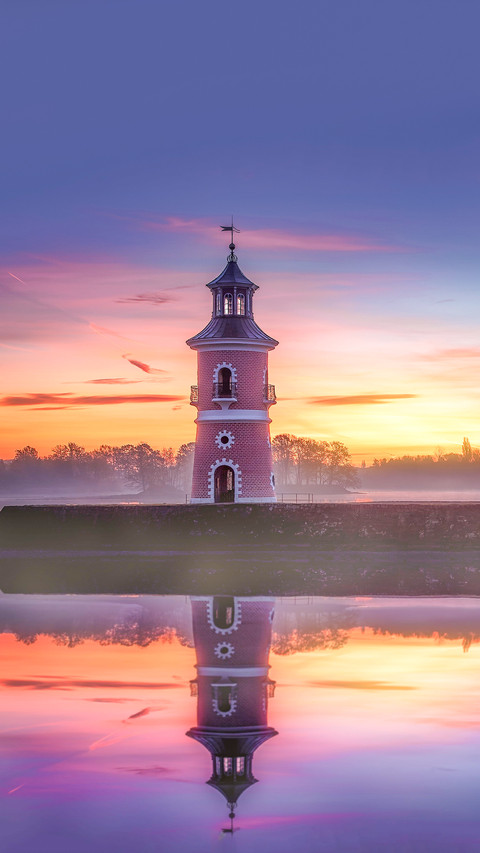 The reflection of Leuchtturm historical landmark at sunset preview
