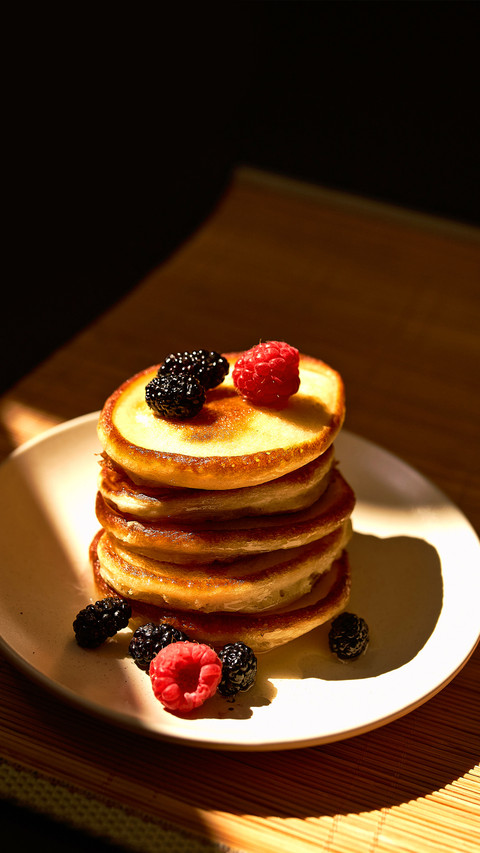 Pancakes with raspberry and honey on the white plate preview