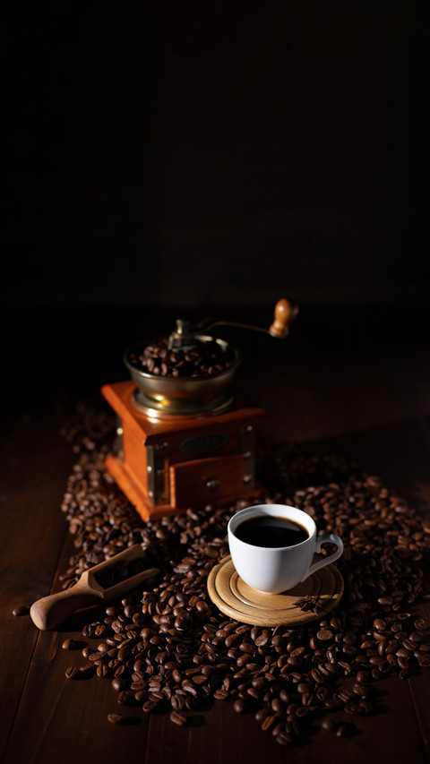 Cup of coffee and beans on wooden table preview