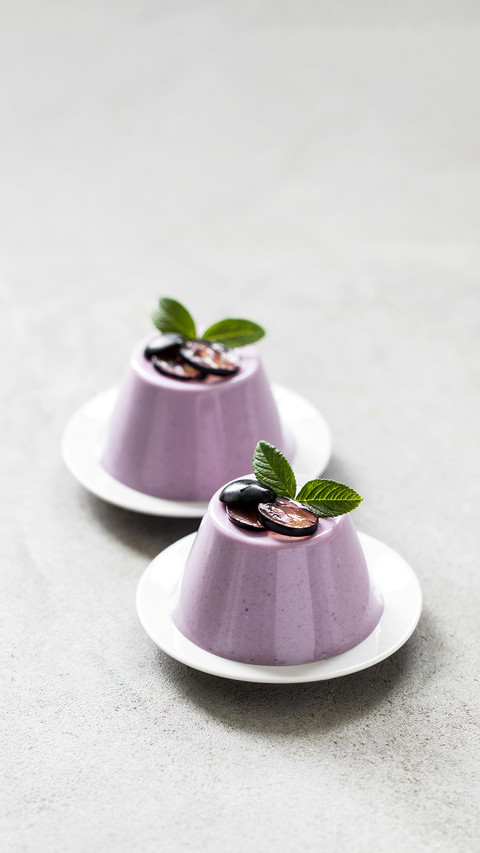 Creamy berry dessert, black grape Panna Cotta on a plate preview