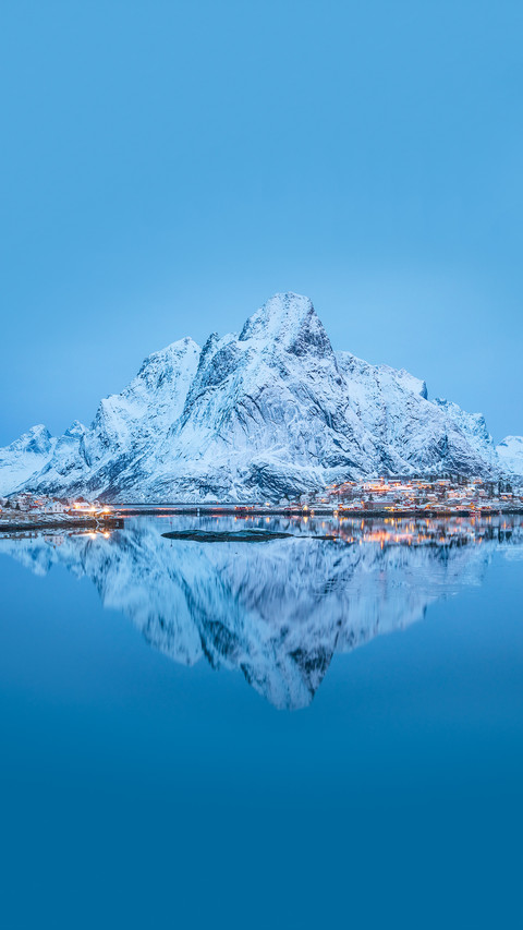 Big snow covered mountain reflected in calm preview