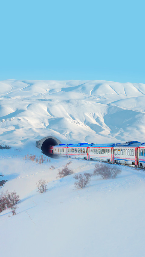 Red diesel train in motion at the snow covered platform preview