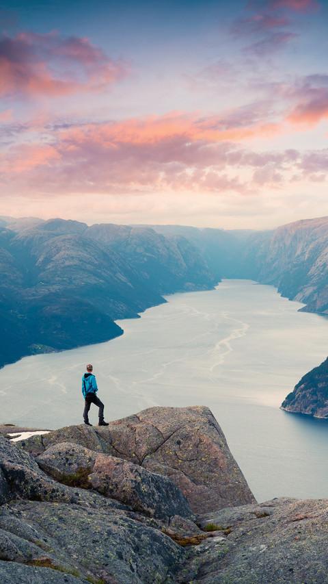 Man Standing on The Cliff Looking at The River Below preview