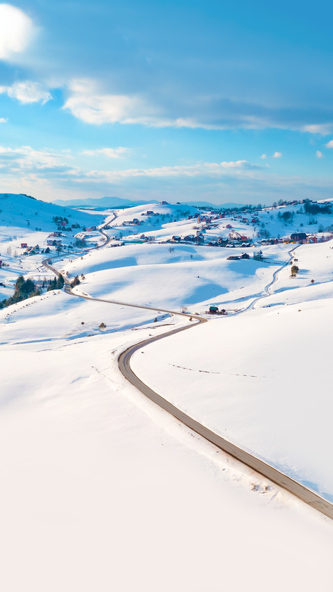 Aerial shot of winter road and frozen mountain creek preview