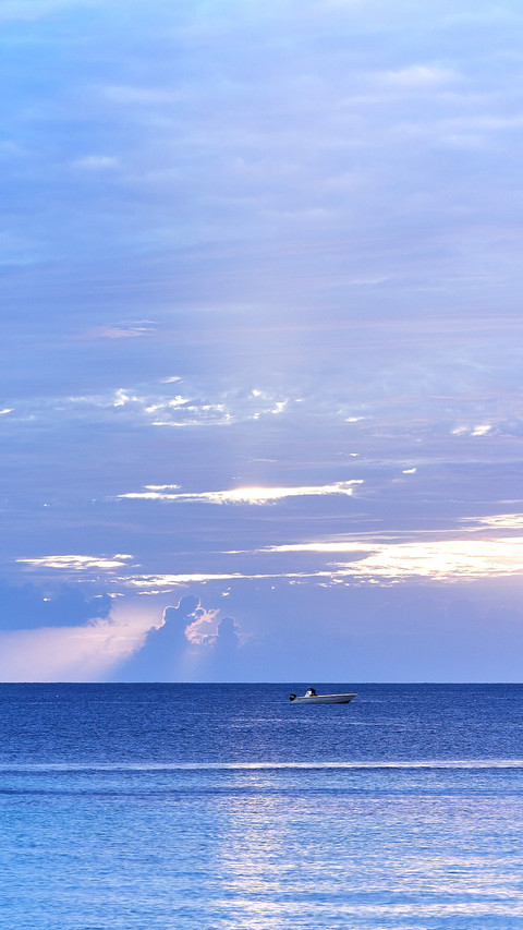 A catamaran anchored in the Caribbean Sea at sunset preview