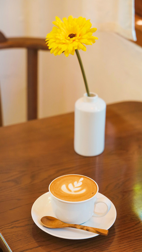 A cup of coffee latte art on wooden table preview