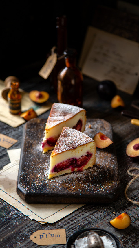 Two slices of baked cheesecake on wooden board preview