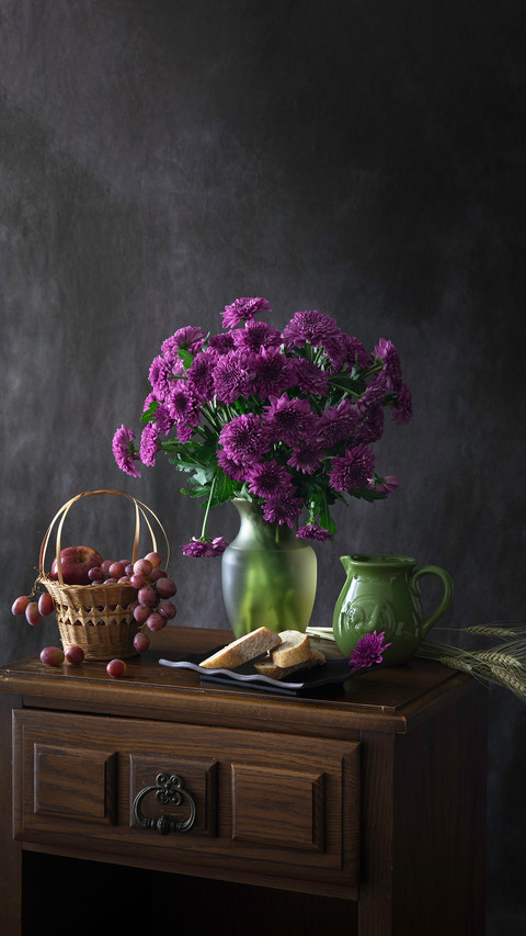 Purple flowers and grapes still life preview