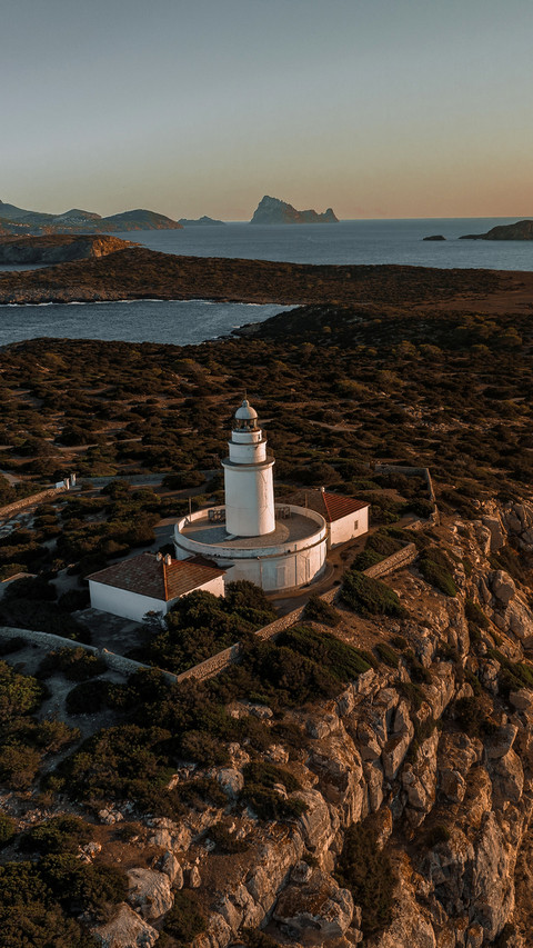 Lighthouse at Sunset on a Tall Cliff Overlooking preview